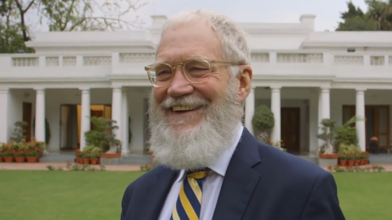 David Letterman in Front of A White Building