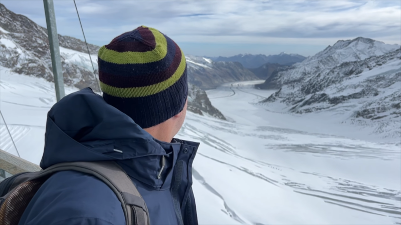 A Person Looks at The Snowy Mountains During a Jungfraujoch Trip in Switzerland