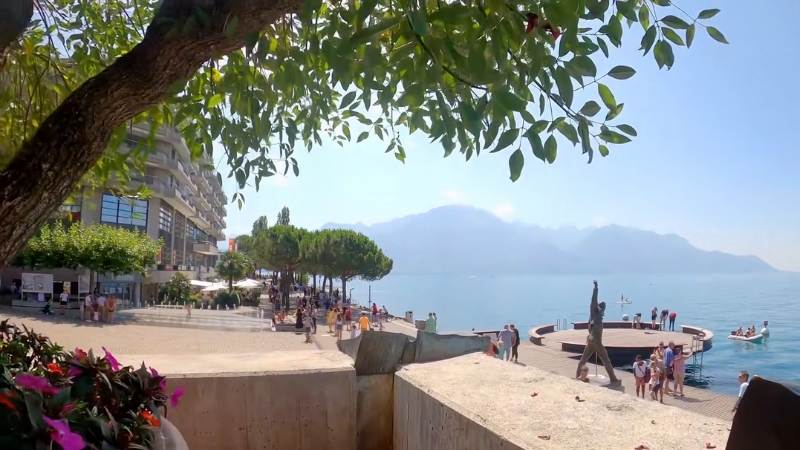 People Stroll Along the Waterfront in Montreux, Enjoying the Views of The Swiss Riviera