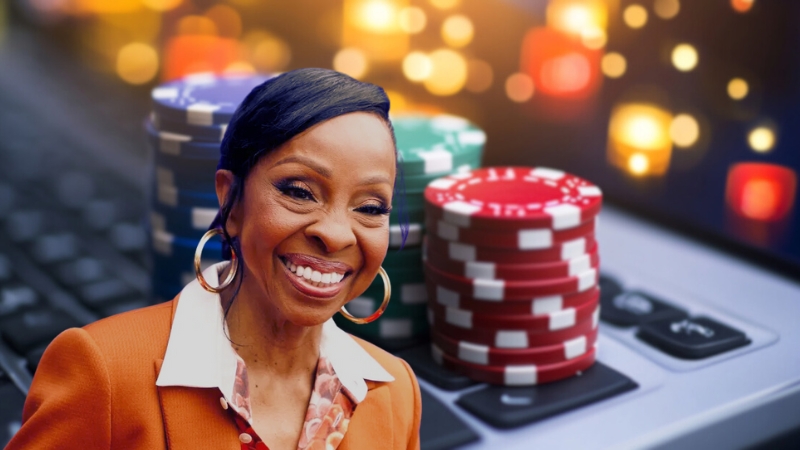 Gladys Knight Smiling with Poker Chips and A Keyboard in The Background