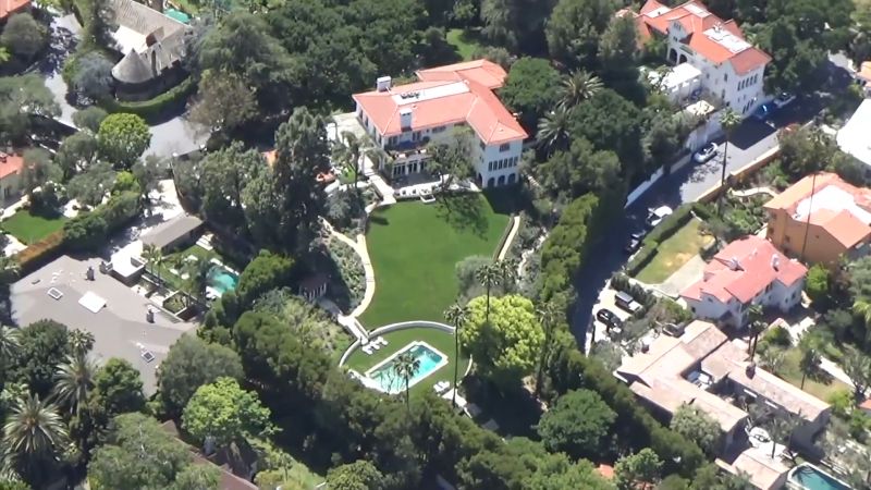 Aerial view of Brad Pitt and Angelina Jolie’s villa with terracotta roof, large lawn, and pool.