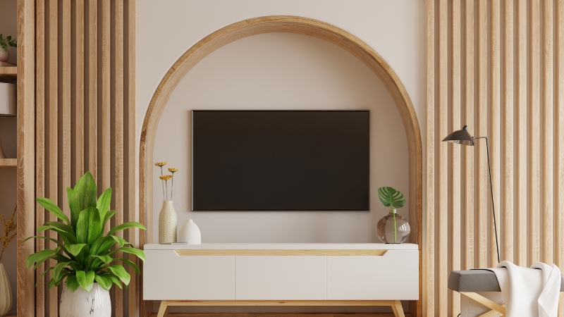 A sleek interior design with a TV integrated into a curved wooden nich