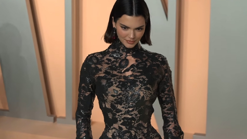 Kendall Jenner wearing a fitted black lace gown with nude lining at the Oscars 2025