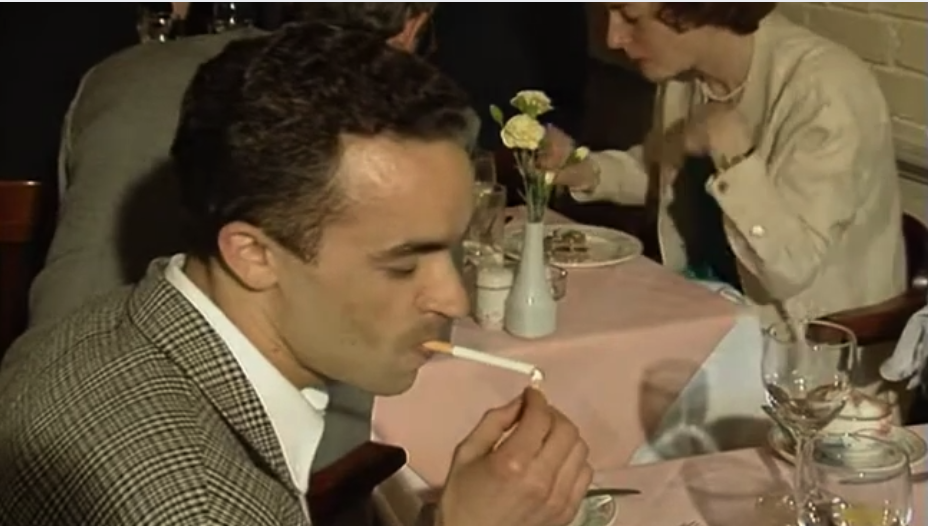 Man smoking a cigarette inside a restaurant