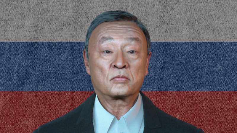 Cary-Hiroyuki Tagawa in front of the Russian flag after becoming a Russian citizen
