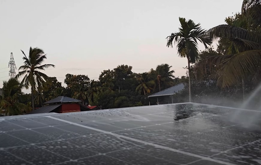 Solar panels being cleaned on a residential roof