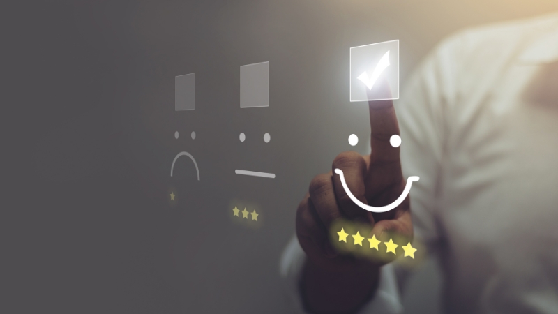 Person selecting a happy face rating