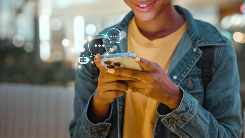 Person chatting with a smart chatbot on a smartphone as part of interactive marketing
