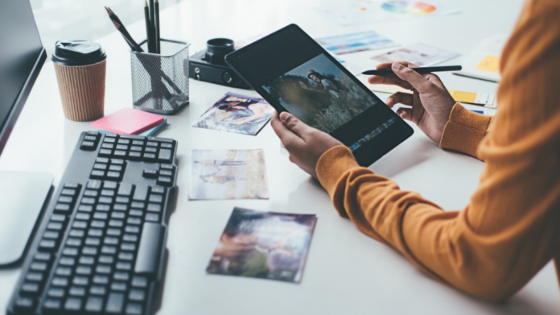 Person editing photos on a tablet for interactive marketing content