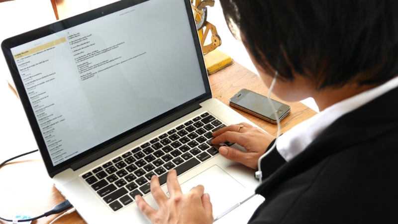 Person typing emails on a laptop, working on a brand promotion campaign