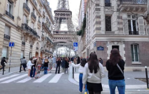 People walking on the street near the Eiffel Tower