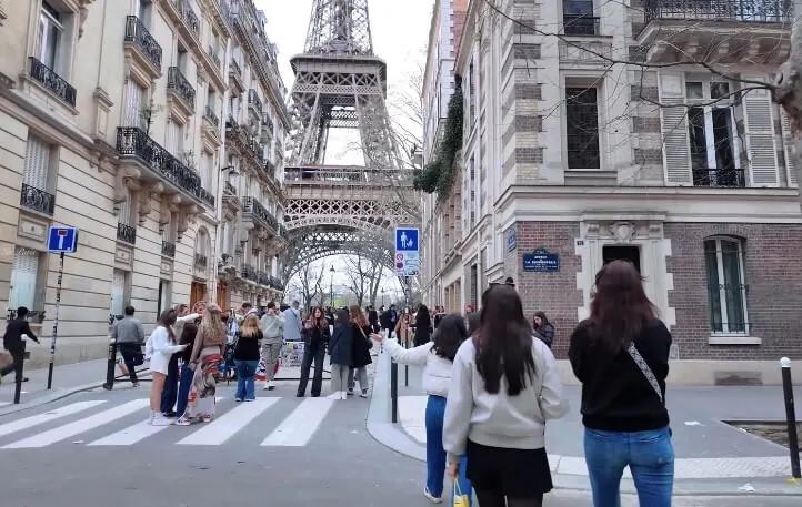 People walking on the street near the Eiffel Tower