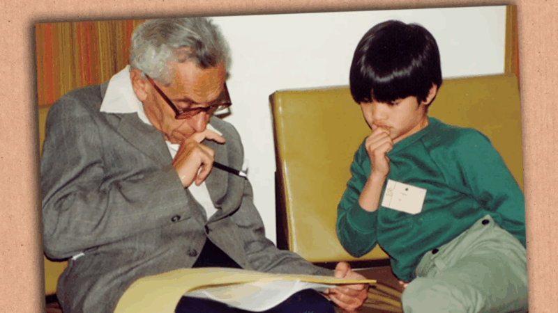 A young Terence Tao sits beside an older man