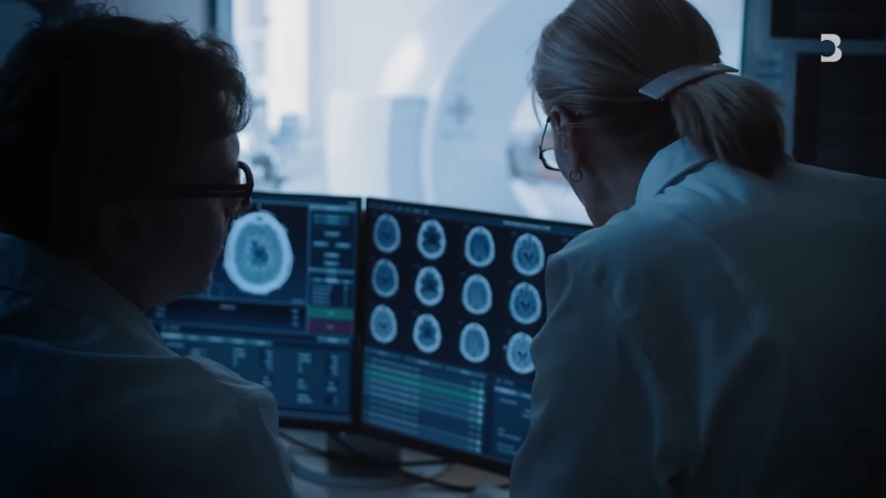 Doctors review brain scan images on computer monitors, showing the role of healthcare and AI in brain research