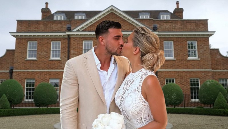 Molly Mae and Tommy Fury kissing in front of new mansion
