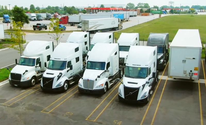 A group of trucks parked in a parking lot