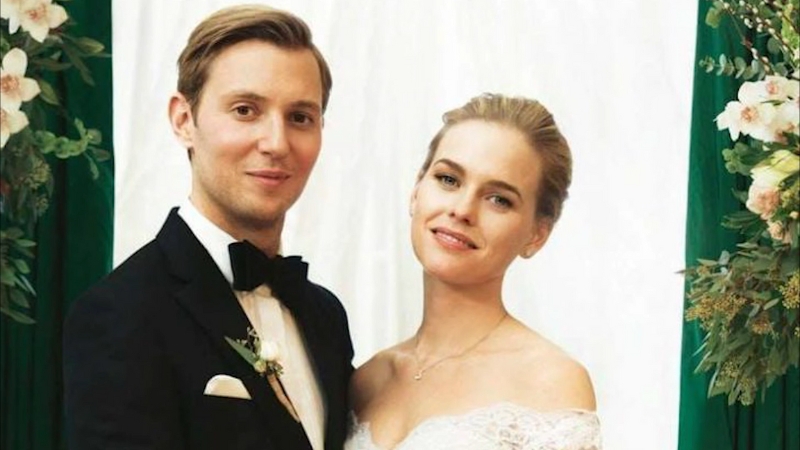 Alex Cowper-Smith and Alice Eve pose together in wedding attire at their ceremony