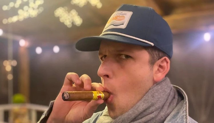 Alex Tombul smoking a cigar