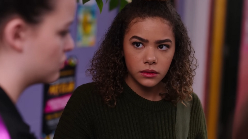 Antonia Gentry in a scene, portraying a character with a serious and thoughtful expression