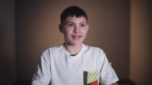 Javon Walton sits in a softly lit room wearing a white shirt