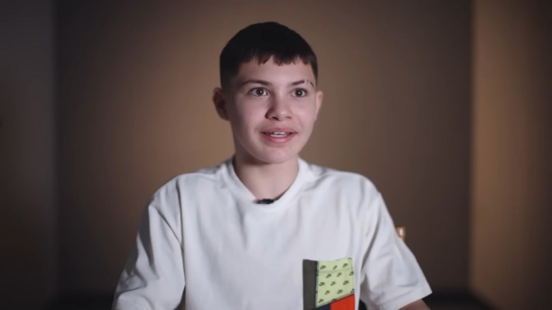 Javon Walton sits in a softly lit room wearing a white shirt