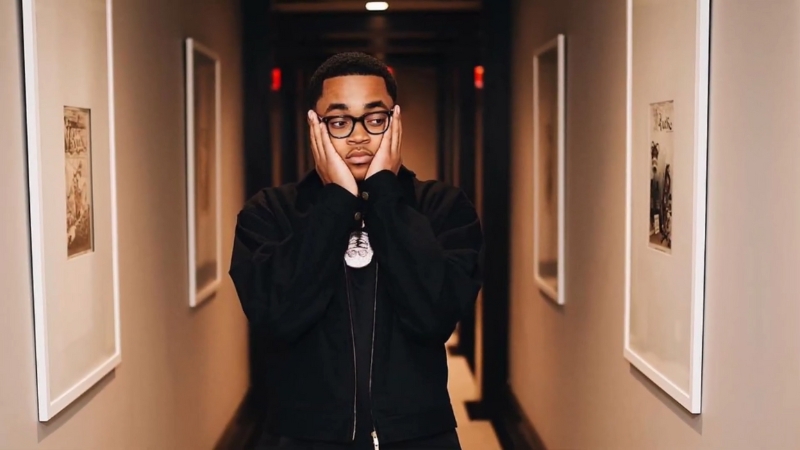 Michael Rainey Jr. standing in a hallway with his hands on his cheeks