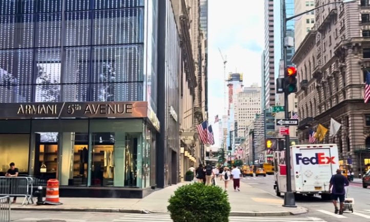 A street scene featuring a large building prominently in the background