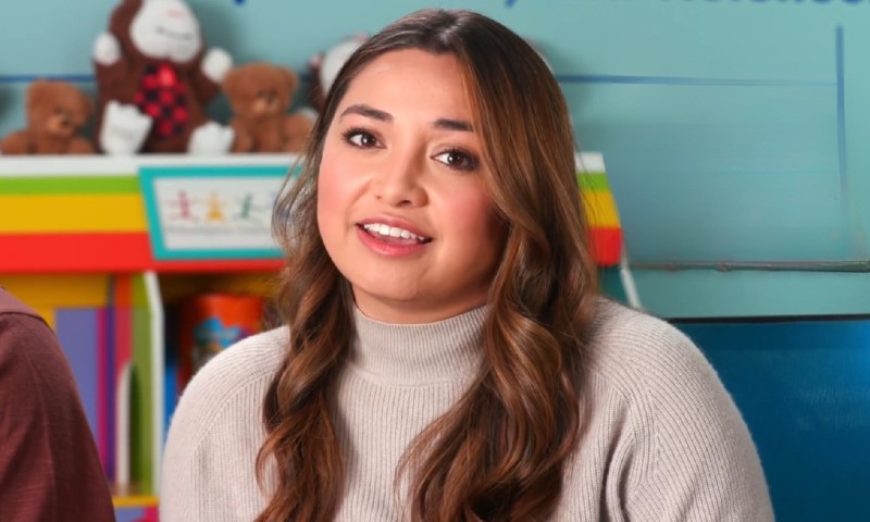 Niki Ikahihifo-Bender speaking in a brightly colored setting with stuffed animals visible in the background