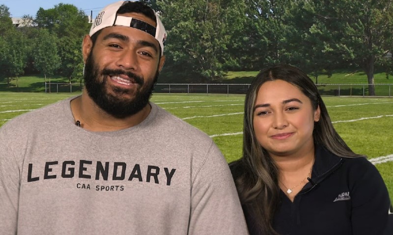 Niki Ikahihifo-Bender pictured smiling in front of a vibrant green football field backdrop