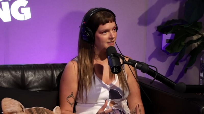 Tove Lo speaks into a studio microphone wearing headphones during an interview