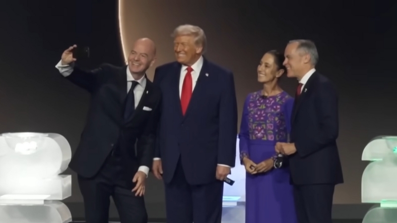 Political leaders and FIFA officials pose together on stage during the 2026 World Cup Final Draw ceremony