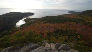 View of coastline and colorful forests inside Acadia National Park during a camping trip in Maine