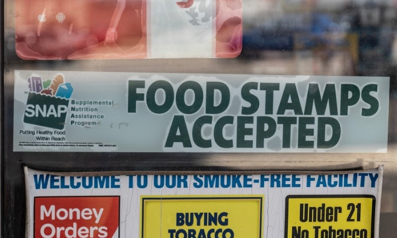 The image shows signs on a store window, including