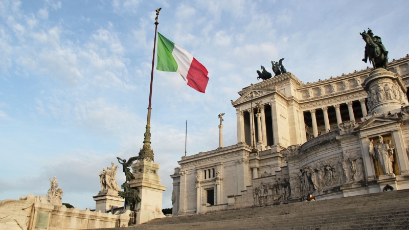 Italian flag flying above the historic Altare della Patria monument in Rome