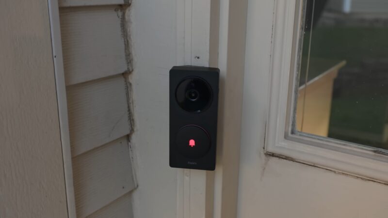 Aqara G410 doorbell camera mounted next to a front door with a glowing button indicator