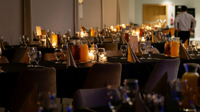 Candlelit private dinner room set for a formal executive event