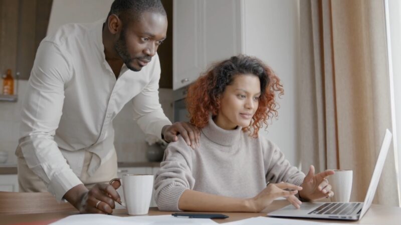 A couple reviews Lifeline eligibility details on a laptop at home