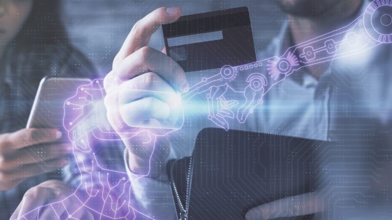 A person holds a bank card beside an AI payment graphic.