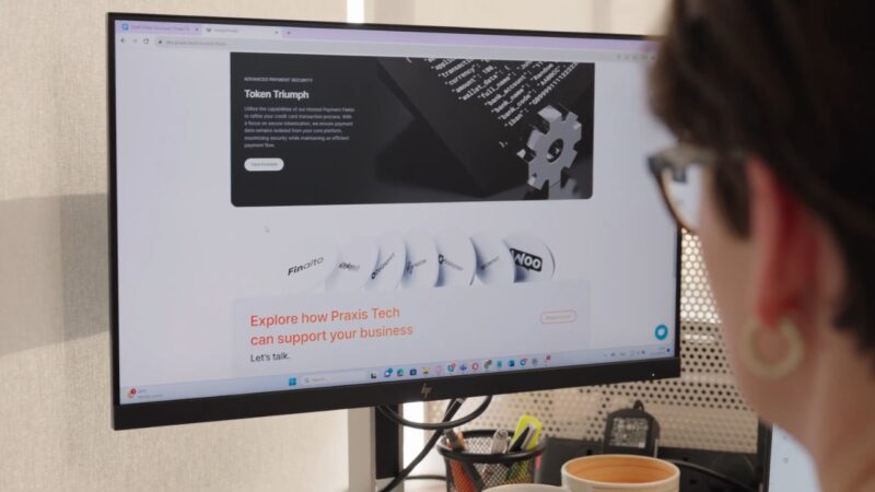 Praxis Tech website on a desktop monitor.
