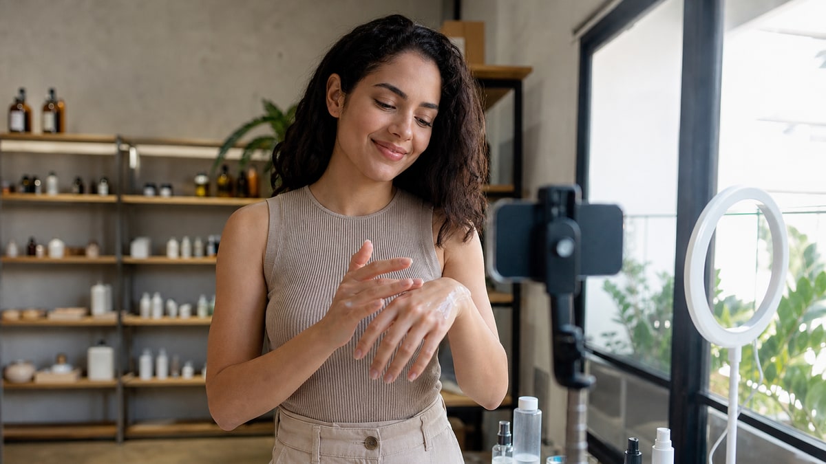 Customer demonstrates an unbranded product while a phone records in a bright showroom.